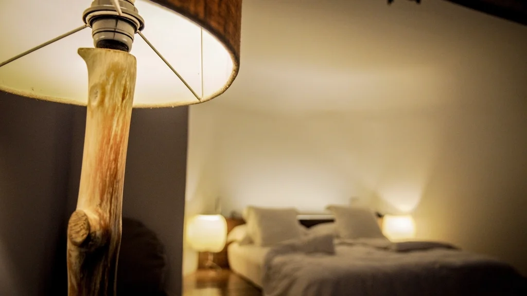Bedside lamp glowing warmly at night, one of the most common smart plug ideas