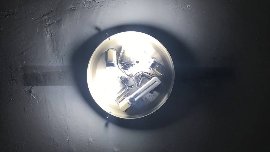 Bright ceiling light fitting seen from below