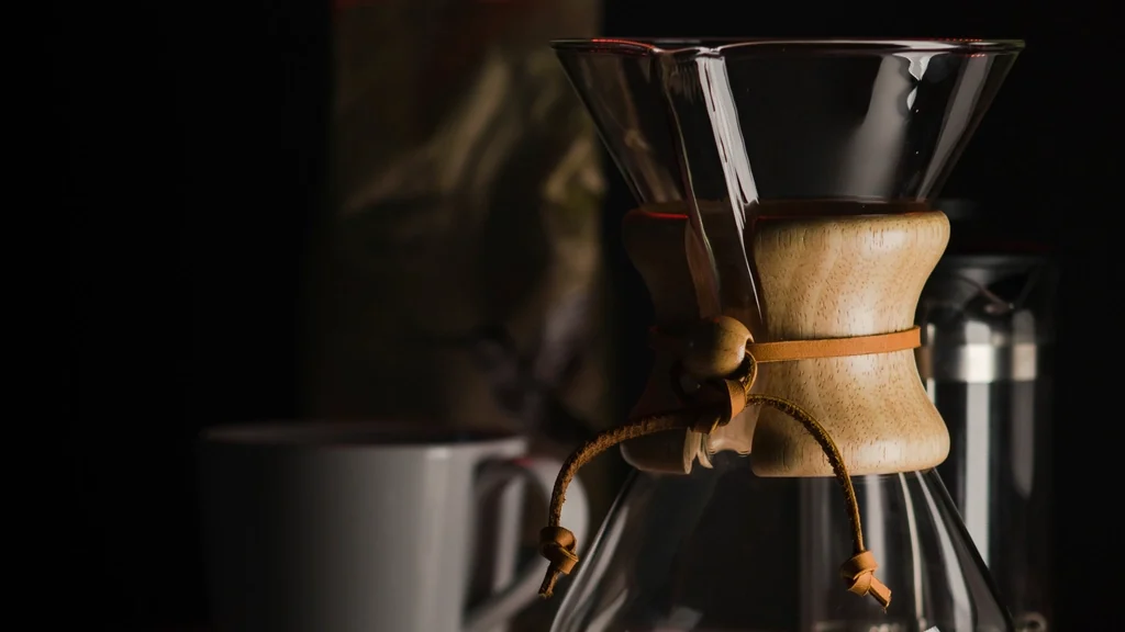 Close view of a coffee machine brewing into a cup