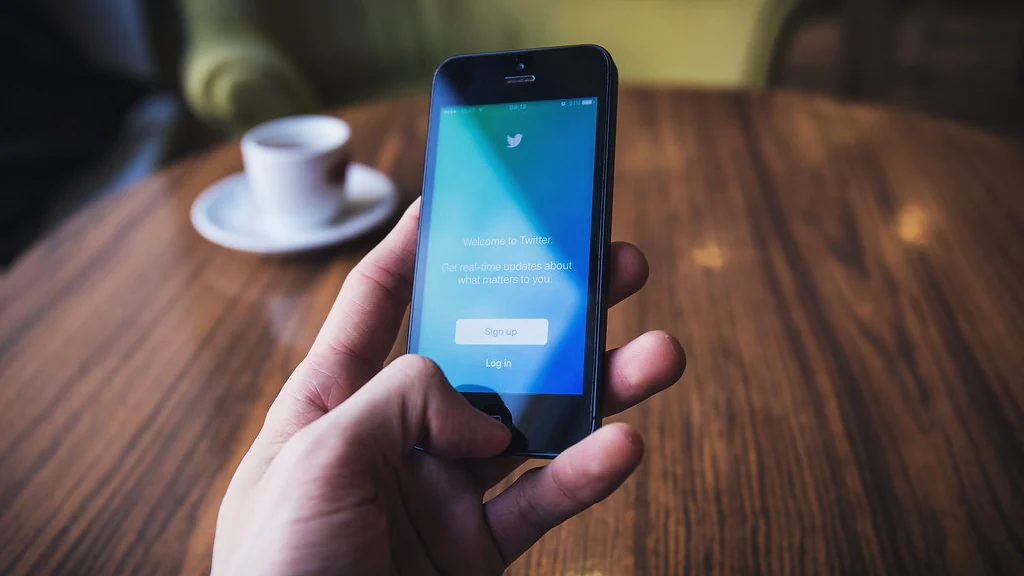Hand holding a phone showing an app, where Alexa routines are created