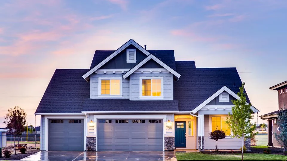 House with a garage and driveway lit at dusk