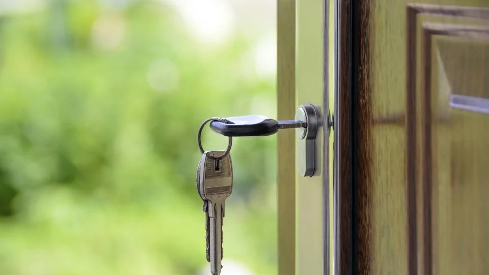 Key in the lock of a front door, a reminder to ask a landlord before fitting anything permanent
