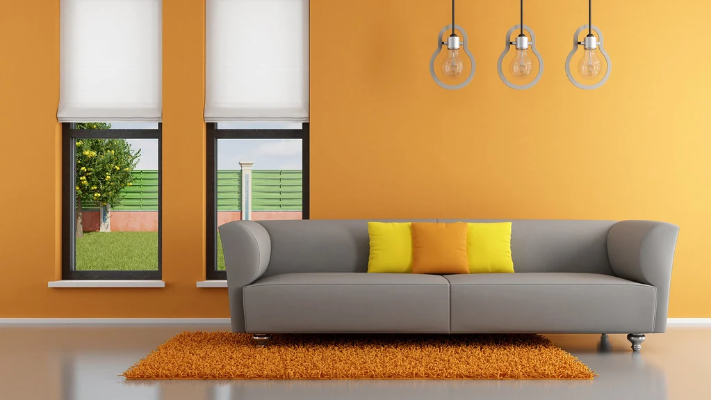 Living room with a grey sofa and lamps, the kind of room where a smart home on a budget usually starts