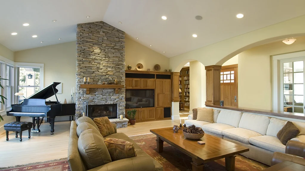 Living room with a television above a fireplace
