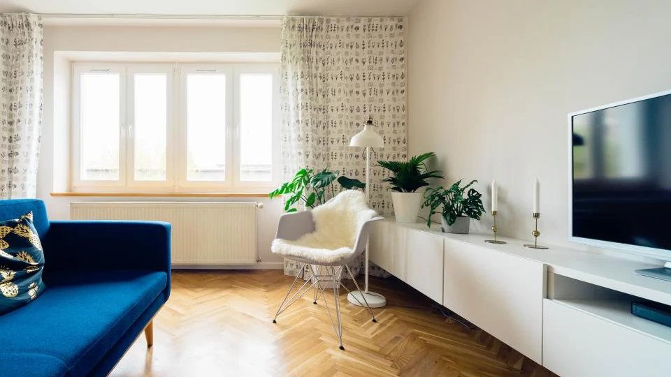 Living room with a wall-mounted television and sofa