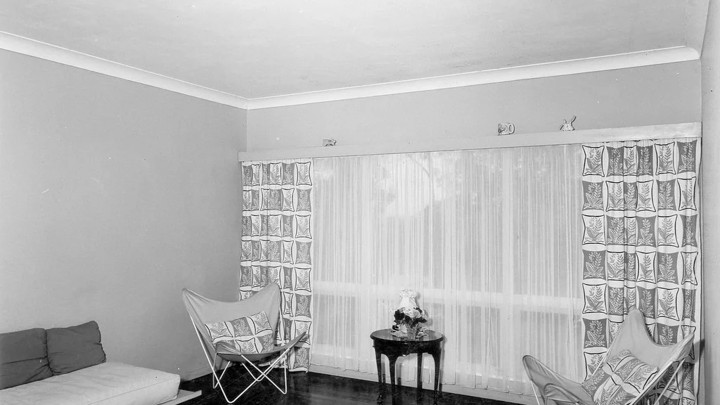 Near-empty rented room with bare walls and curtains, the state it should be left in