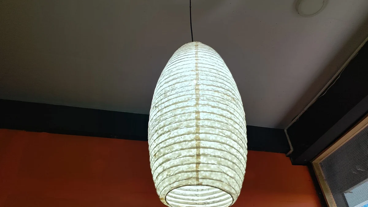 Paper lantern pendant light in a plain room