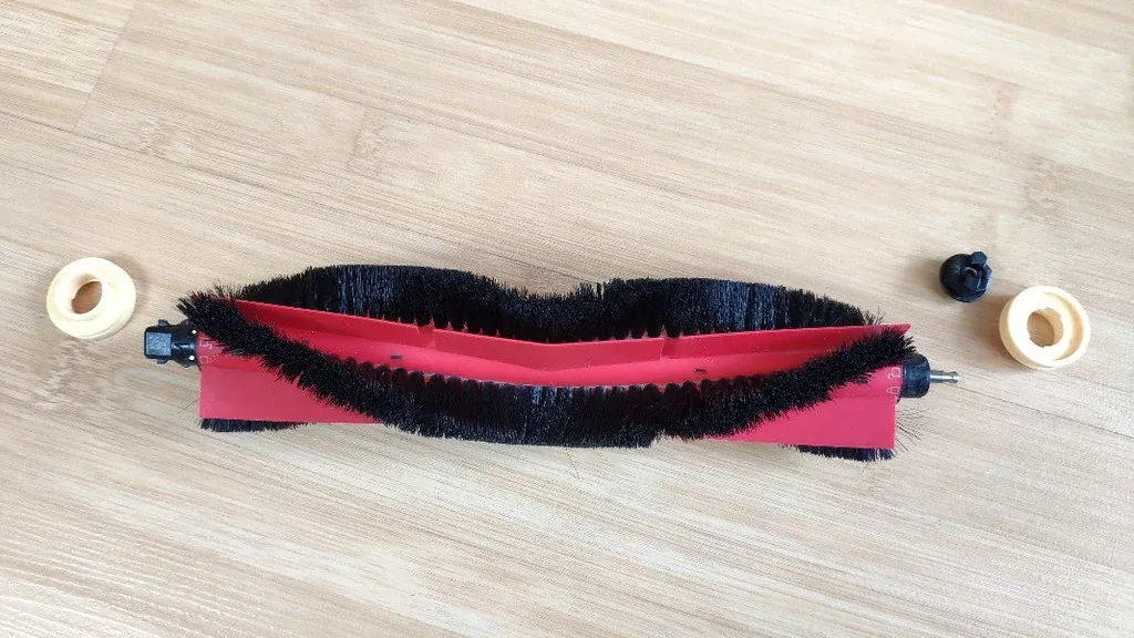 Robot Vacuum Maintenance: 7 Easy Steps and a Schedule Brush roll removed from a robot vacuum for cleaning, a core part of robot vacuum maintenance
