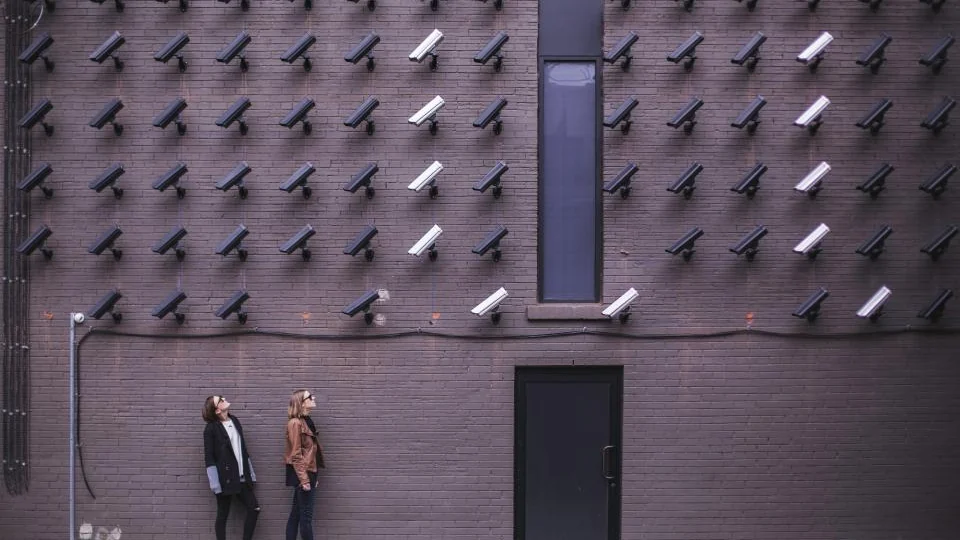 Surveillance camera fixed to a brick wall outdoors